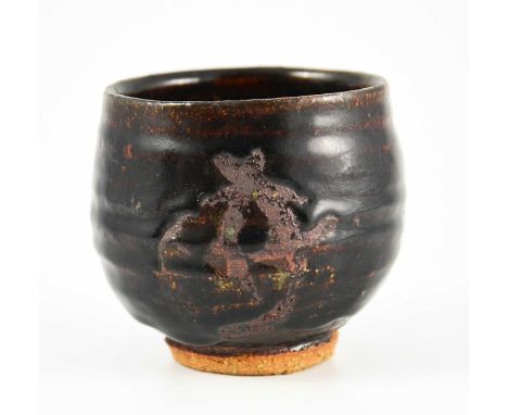 Jeremy Leach (attributed), a studio pottery tea bowl or vase, circa 1954, tenmoku glazed with unglazed Japanese symbol decora