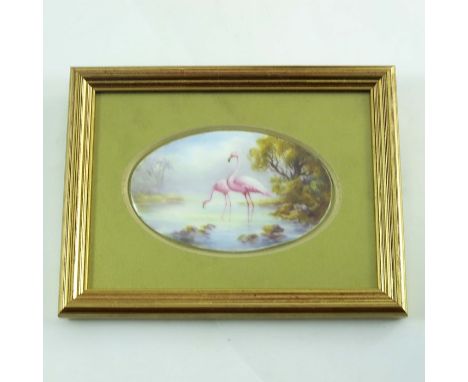 C Johnson for Royal Worcester, an oval plaque, 1913, painted with flamingos in a lake, 9.5cm wide