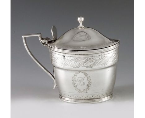 John Emes, London 1799, a George III silver mustard pot of oval navette form, the body with engraved leaf, scroll and laurel 
