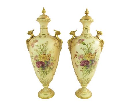 A Pair of Royal Worcester blush ivory urn vases and covers, the body florally decorated in coloured enamels between gilt and 