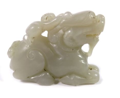 A Chinese jade carving of a boy on the back of a dragon, 8cm