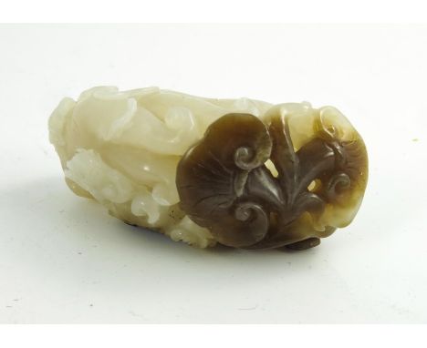 A Chinese Jade Carving of a Finger Citron, pale white and brown tones, 7cm high 