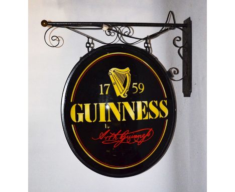A modern double sided illuminated pub sign advertising Guinness, in perspex suspended on metal bracket, overall 96cm high x 8