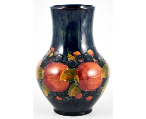 William Moorcroft, a Pomegranate on blue vase, circa 1928, straight necked baluster form, impressed marks and facsimile signa