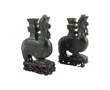 A Pair of Chinese Spinach Green Jade Carved Bird Vases, cirac20th century, the carved stylised phoenix bird with square stepp