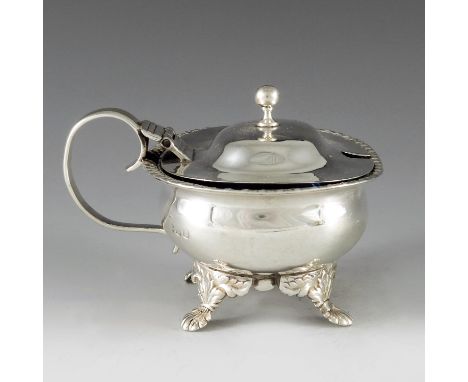 Thomas Dicks, London 1818, a George III silver oval mustard pot raised on shell scroll feet, gadrooned borders, shallow domed