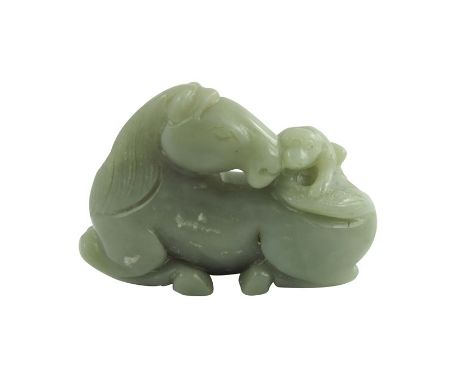 A Chinese Jade Horse, the finely carved recumbent horse, its head turned back surveying a small monkey on its back holding th