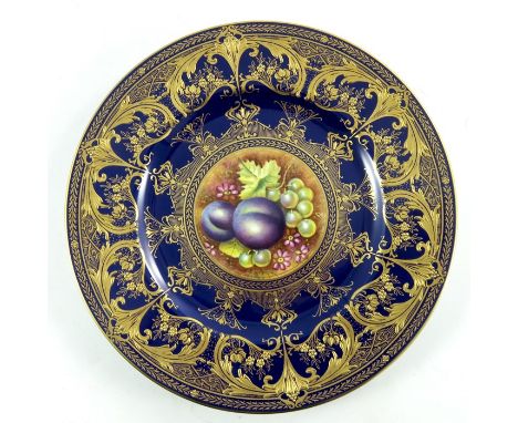 Leaman for Royal Worcester, a fruit painted plate with gilt border, plums and grapes, cased, 27cm diameter