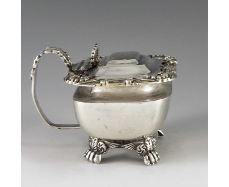 Solomon Hougham, London 1817, a George III silver mustard pot, of rectangular form, the plain body raised on four decorative 