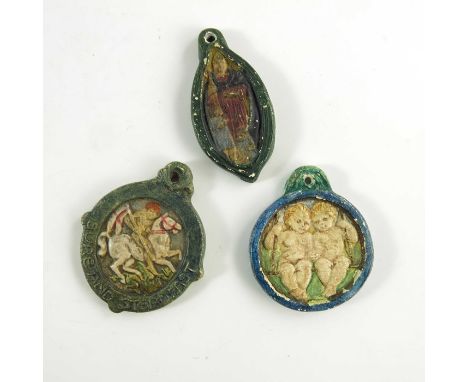 Mary Watts for Compton Pottery, three ceramic pendants, relief moulded, including St Nicholas, St George and Gemini, 5.5cm lo