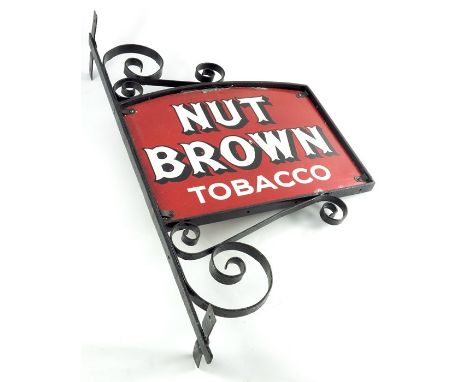 A double sided enamel sign for NUT BROWN TOBACCO, within an iron frame, sign 46cm x 34.5cm, frame 81.5cm high