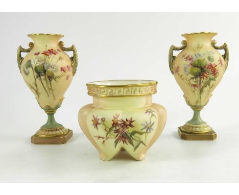 A pair of Royal Worcester miniature blush ivory ground two handled vases, florally decorated with thistles and wild flowers i