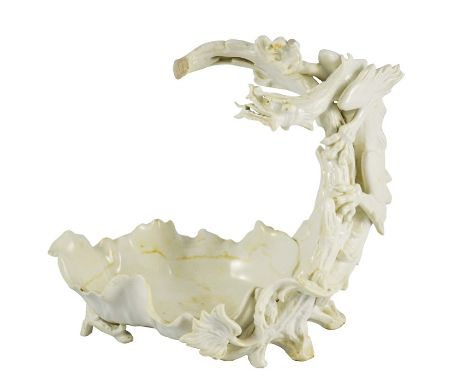 Charles Noke for Doulton Burslem, a blanc de chine figural dragon centrepiece bowl, circa 1890, modelled in relief with a Jap