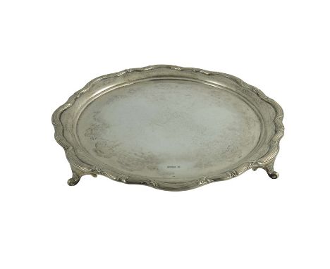 A large George V silver salver, James Deakin and Sons, Sheffield 1930, circular form with ogee serpentine rim, cast with ribb