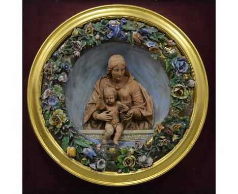 A Della Robbia plaque in a glass case, Italian 19th century, gilded frame, mounted on board, plaque 90cm wide