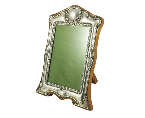 An Elizabeth II silver photo frame, W I Broadway and Co., Birmingham 1979, embossed foliate scroll borders and bracket feet o