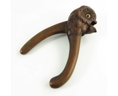 A Hand Carved Wooden Nutcracker in the form of an owl with glass eyes, late 19th/early 20th century, 20cm long 
