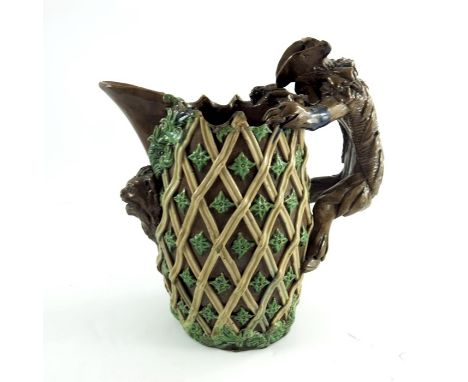 Edward Bingham for Castle Hedingham, an art pottery jug, lattice and foliate decoration with figural handle and bear below sp