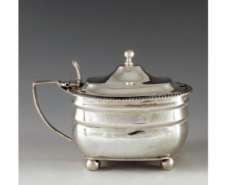 Solomon Hougham, London 1809, a George III silver mustard pot of rectangular moulded oval form, raised on ball feet, and with