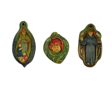 Mary Watts for Compton Pottery, three ceramic pendants, relief moulded, including St Francis, St Nicholas and a Putto head in