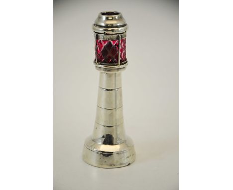 An Edwardian novelty silver table lighter, Grey and Co., London 1903, in the form of a light house, with hobnail cut ruby cas