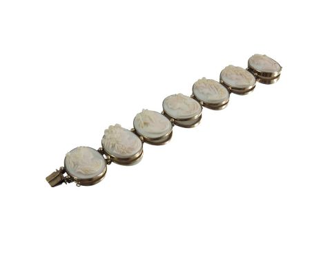 A Victorian yellow metal and cameo set bracelet, seven portrait ovals of Classical women in profile with various headdresses,