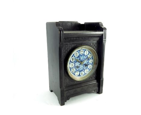 An Aesthetic Movement ebonised bracket clock, in the style of Lewis Foreman Day, circa 1880, the 5 inch blue and white cerami
