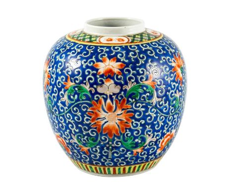A Chinese famille rose ginger jar, enamelled with lotus flowers on a blue foliate scroll ground, four character mark, 23cm hi
