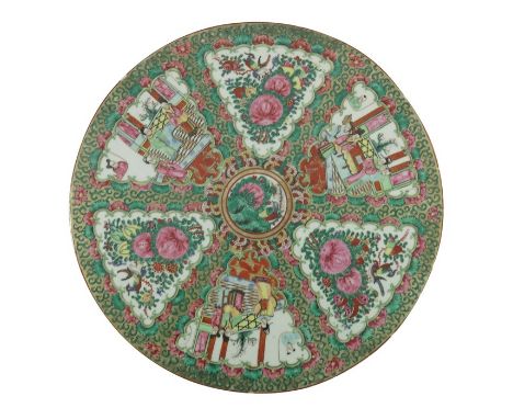 A Chinese famille rose plaque, Cantonese, circular form, painted with alternating floral and domestic panels, within a gild a
