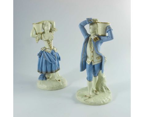James Hadley for Royal Worcester, a pair of hand painted porcelain figural candlesticks, circa 19th century, modelled as a ma
