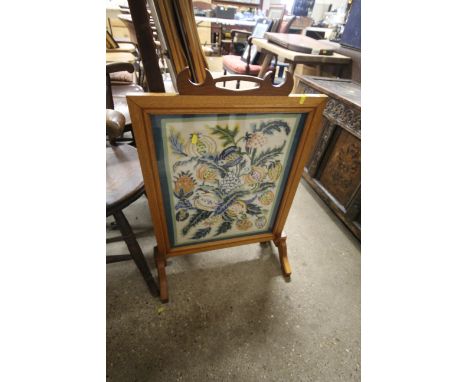 An oak needlework fire screen