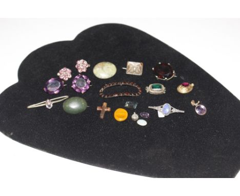 A box containing various semi-precious stone; other coloured stones; an opal set bar brooch etc. 