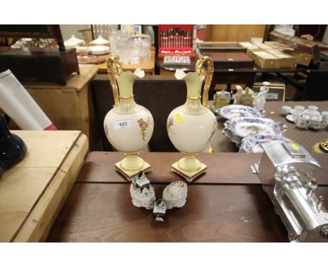 A pair of Royal Worcester style ewers; and two Faring style ornaments AF