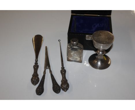 A silver Communion cup with refill bottle and case; and a silver handled shoe horn, button hook, and gloves stretchers 