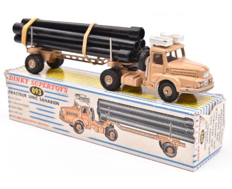 A French Dinky Supertoys Tracteur Unic Saharien (893). In beige with beige wheels and 6x plastic pipe load. Boxed, some wear.