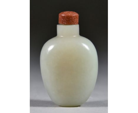 A Chinese Celadon Jade Snuff Bottle, Ching Dynasty 19th Century, of ovoid form with slight russet inclusion 2.375ins (6.1cm) 