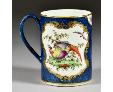 A Worcester Scale Blue Mug, Circa 1768-72, enamelled in colours with exotic birds within shaped reserves outlined in gilt, sc