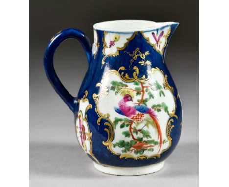 A Worcester Scale Blue Milk Jug, Circa 1768-72, enamelled in colours with exotic birds and butterflies within shaped reserves