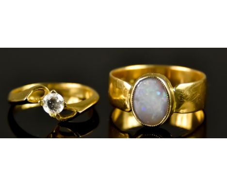 Two 18ct Gold Rings, 20th Century, one set with an opal, 10mm x 7mm, size T,  the other set with a paste stone, size M, total