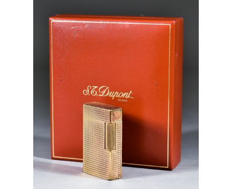 A Dupont Gilt Metal Lighter, with engine turned ornament 2.375ins high, in original case