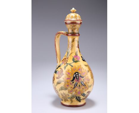 A ZSOLNAY PECS EWER AND COVER, CIRCA 1870-80, decorated in the Persian taste with foliage, the handle in the form of a snake,