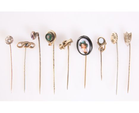 NINE VARIOUS STICK PINS, INCLUDING AN ENAMELLED PORCELAIN EXAMPLE (9)