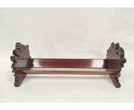 Victorian mahogany book trough with carved floral ends. 19 cm high, 50.5cm wide, 19.5cm deep. 