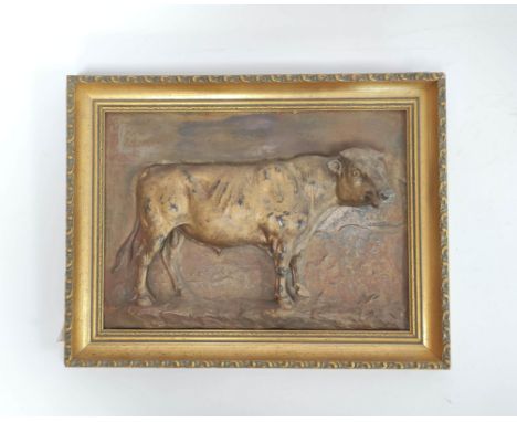 Continental cast bronze plaque in the form of a bull in relief in naturalistic setting, signed indistinctly to lower left, 25