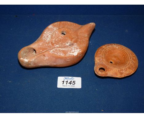 An unusual Roman red pottery oil lamp, c.2nd 3rd century AD, probably North African, with an impressed design to the rim and 