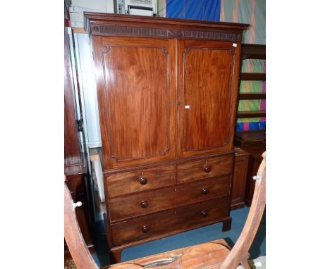 A 19th c Mahogany Linen Press, the pair of opposing doors revealing an interior with four slides, the base standing on bracke