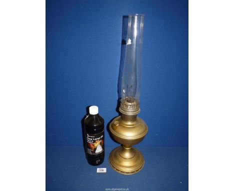A Victorian brass Aladdin oil lamp with glass chimney and bottle of lamp oil, 23 1/2" tall.