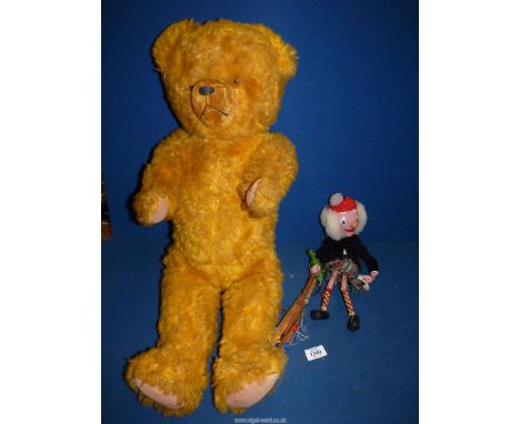 A very large yellow vintage straw filled, jointed Teddy bear, fitted with growler but not working properly, 32" tall, plus a 