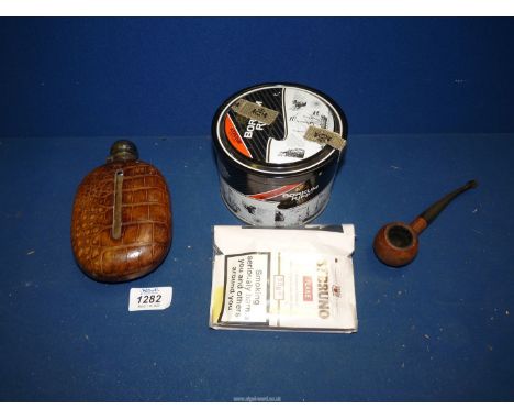 A Crocodile hip flask and a Pipe with a sealed pouch of St. Bruno plus an opened tin of Borkum Riff tobacco.