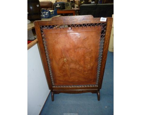 A fire screen with central leather panel of a sailing ship.